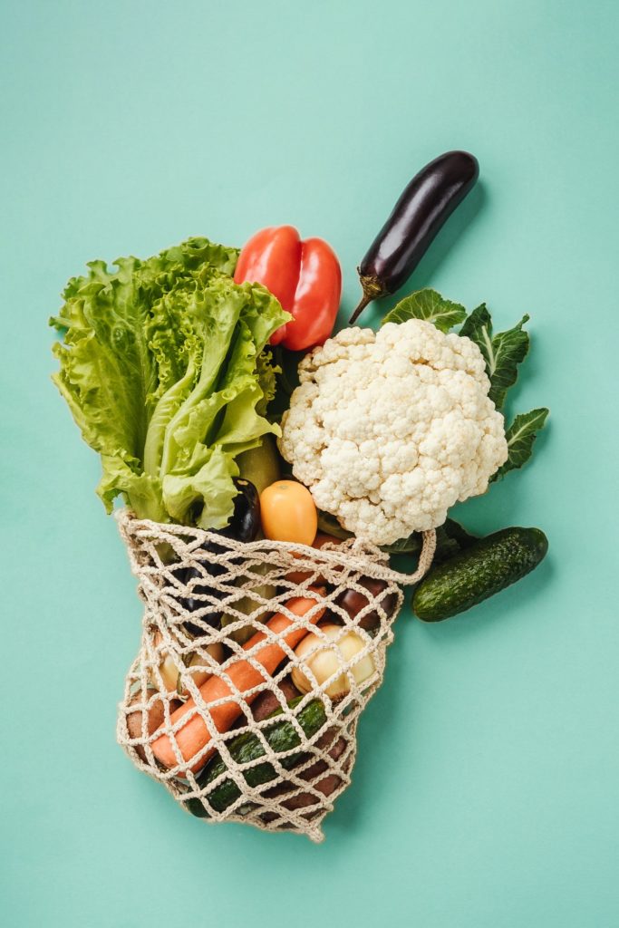 Various fresh food - vegetables in eco-friendly bag.